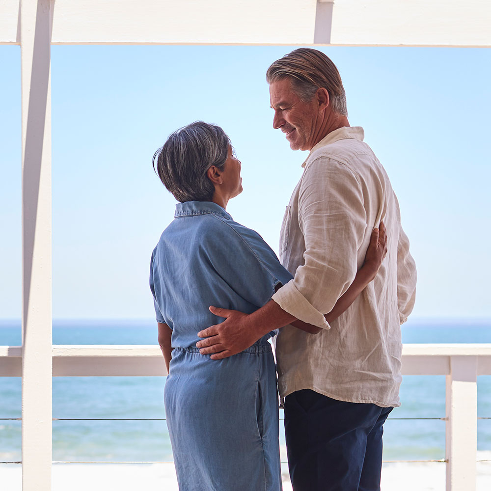 loving-mature-couple-hugging-in-beachfront-house-o-2024-10-20-09-46-43-utc